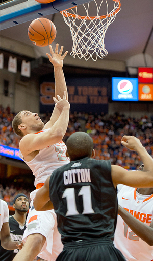 Syracuse shooting guard goes up for a layup over Providence point guard Bryce Cotton. Triche and the Orange broke off a 27-2 run to end the first half and put away the Friars.