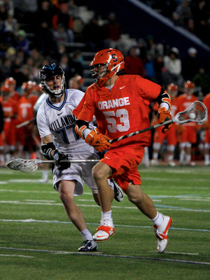 Syracuse midfielder Luke Cometti looks to break free from Villanova midfielder Remington Pope in the Orange's 11-10 loss to Villanova on Saturday. Cometti scored two goals in the game.