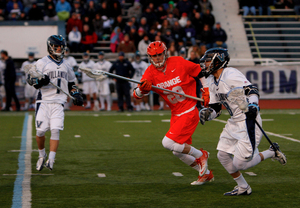 Villanova's Max Hart carries the ball past Syracuse long-stick midfielder Peter Macartney in the Orange's 11-10 loss to the Wildcats on Saturday. Villanova went 22-of-24 at the faceoff X, giving it ample possessions to knock off the Orange. 