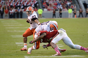 Prince-Tyson Gulley dashes around a Clay Cleveland block in Syracuse's 24-10 win over North Carolina State on Saturday.