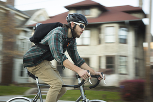 Neil Hueber, a Mello Velo bike shop employee, returns from making a delivery to Lawrinson Hall. Melo Velo Cafe has recently began a delivery service with bike shop employees. 