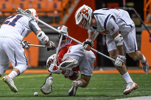 Brandon Mullins lays out a Cornell player in Syracuse's 14-6 win. Syracuse's defense held the Big Red attack to just one goal. 