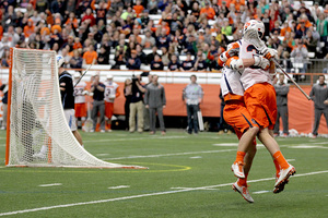 Paolo Cifferi (right) celebrates with a teammate after scoring a goal last Saturday against Johns Hopkins. He's grown into an expanded role as a defensive midfielder for SU after an injury hindered him last year.