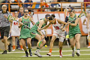 SU's Taylor Poplawski is swarmed by a crowd of Notre Dame players. The Fighting Irish used an aggressive approach to help propel it to a win on Tuesday. 