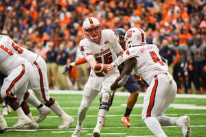 In 2016 playing at the Carrier Dome, NC State's efficient signal-caller Ryan Finley hands off to Reggie Gallaspy II, who has assumed a larger role with the Wolfpack's rushing attack this season.