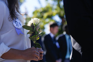 Students lay a rose in honor of the Pan Am Flight 103 terrorist attack victim they represent.