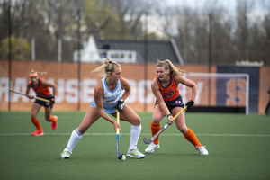 Syracuse midfield SJ Quigley plays defense on a North Carolina forward.