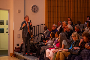 Chancellor Kent Syverud (left) provides financial updates at the Syracuse University Senate's first meeting of the semester. SU finished the fiscal year with a surplus of $1.5 million, he said.