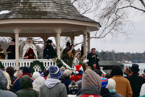 In Skaneateles, New York, people in costumes gather for caroling and holiday music. The actors interact with tourists in their characters of choice.