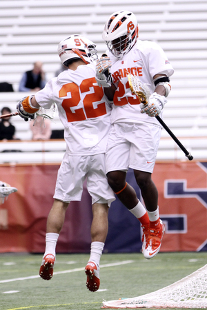 JoJo Marasco (22) and Jovan Miller celebrate during SU's 13-7 win over Denver on Sunday.