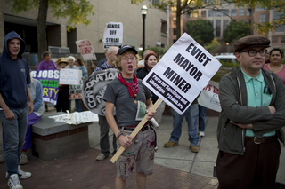 Laura Brown, one of the original members of the Occupy movement in Syracuse, yells at the beginning of the group's march.