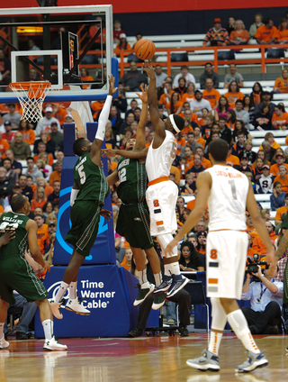 Syracuse forward C.J. Fair tries a baby hook over the Wagner defense.