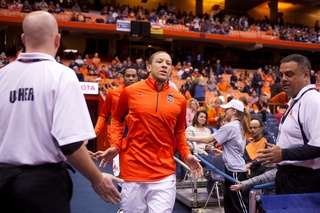 Syracuse University guard Brandon Triche runs out of the locker room and onto the court prior to tipoff Thursday night in the Carrier Dome.