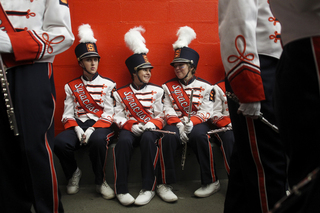 (From Right) Syracuse marching band Amy Hahn, sophomore, Alexis Rinck, freshman, Jaime Yavorsky, senior, chat before taking the field.