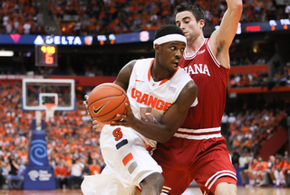 Syracuse forward C.J. Fair drives on Sheehey.