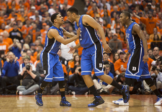 Cook and Parker celebrate after Parker completed a basket and drew a foul.