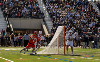 Rice curls around the crease from behind net, looking to attack.