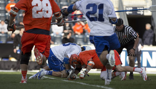 Chris Daddio and Brendan Fowler fight for a faceoff early in the game.