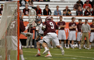 A Syracuse players looks for cutting teammates while being defended. 