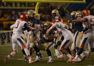 James is caught in between two SU tacklers near the line of scrimmage.