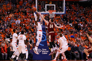 Christmas corrals a ball near the rim as BC's Dennis Clifford puts his left hand in the big man's face.