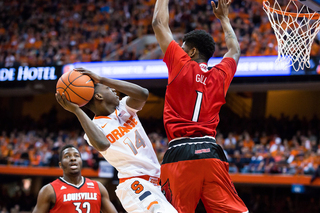 Freshman point guard Kaleb Joseph rises for a contested layup against Louisville sophomore Anton Gill.