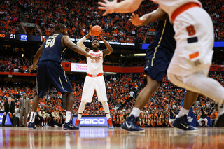 Christmas looks down the court to Trevor Cooney for an opening.