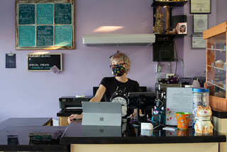 Pawsitivitea owner Alisha Reynolds stands at the counter of the cafe.