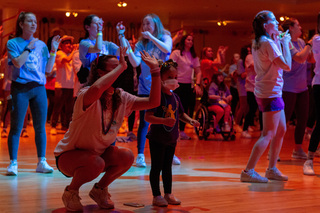 One of the miracle family children dances the moral dance with students before the first break of the day. 